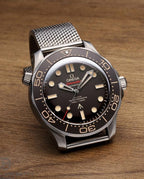 Omega Seamaster “007 Edition” Master Quality Watch – Black Dial, Bronze Gold-Tone Bezel & Stainless Steel Mesh Bracelet